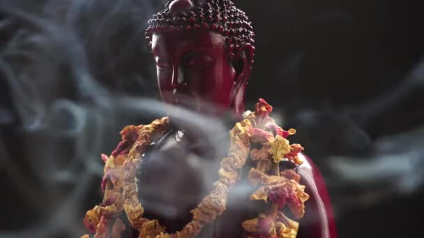 Buddha statue with incense. Deity and symbols of Buddhism. The practice of Buddhism and its symbols. Spiritual life of Asia — Stock Video