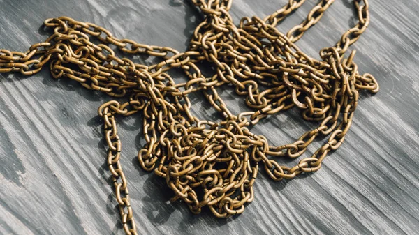 Gold chain from the wall clock. Close-up metal chain for watches — Stock Photo, Image