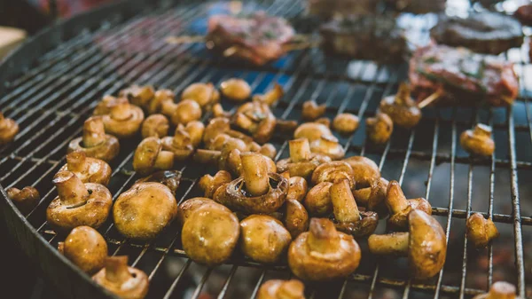 mushrooms on the grill. Cooking mushrooms on the grill. Vegetarian cuisine. Shallow focus