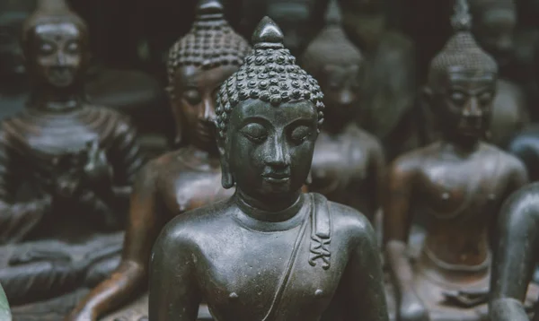 Старые статуи Будды на местном рынке крупным планом. Будда как символ буддизма в Таиланде и Азии. Портрет Будды в статуевом формате на местном рынке — стоковое фото