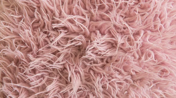 Artificial fur of pink color. Fashion goes to artificial fur