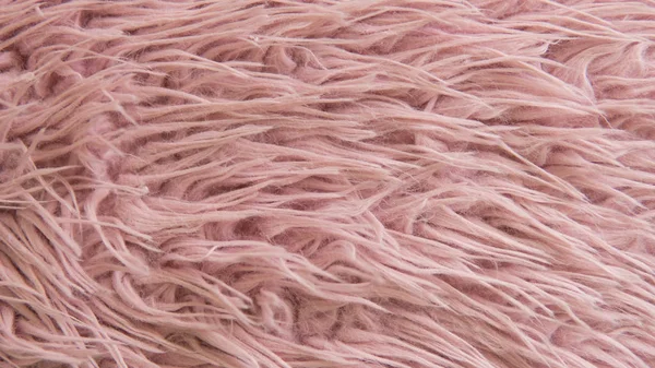 Artificial fur of pink color. Fashion goes to artificial fur
