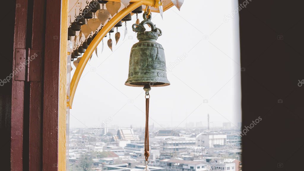  Buddhist bells in the monastery close-up. Wat Saket in Bangkok - Temple of the Golden Mount