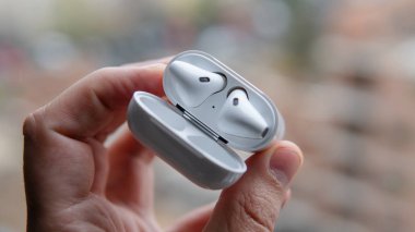 Beyaz bir çantadaki kablosuz kulaklıklar. Müzik severler için modern ses teknolojisi