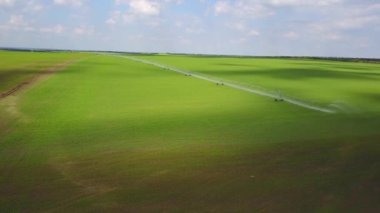 Modern otomatik sulama ekipmanları taze sulama alanı seçilir. Ürün kalitesini garanti etmek için tarım arazileri sulama. Sulama makine bir buğday alanında İnternet havadan görünümü bağlı