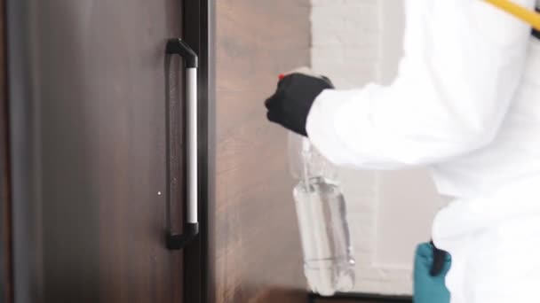 Close view of hand in medical glove using antibacterial sprayer, wipe for disinfecting door knob. Disinfection and cleaning of doorhandles. Germs, bacteria, Covid-19, SARS, Coronavirus pandemic. — Stock Video
