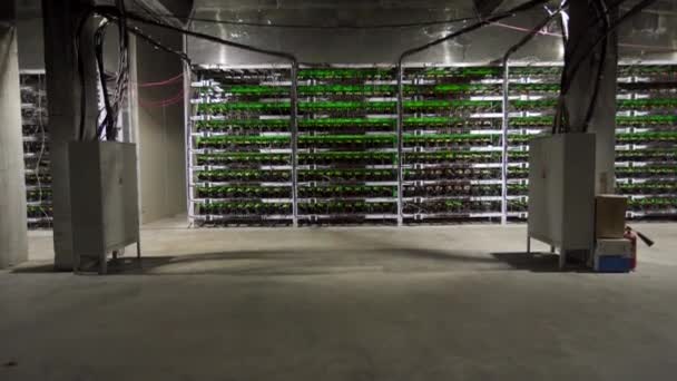 Cryptogeld mijnbouw apparatuur op grote boerderij. ASIC mijnwerkers op tribune rekken de mijne Bitcoin in serverruimte. Blockchain techologie applicatie specifieke geïntegreerde schakeling. Statief kantelen. — Stockvideo