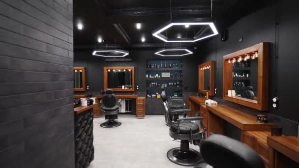 Vintage barbershop interior - movement along the chairs, wooden tables and mirrors. Stylish hair studio indoors. Stylish beauty salon design with modern lighting and lamps. — Stock Video