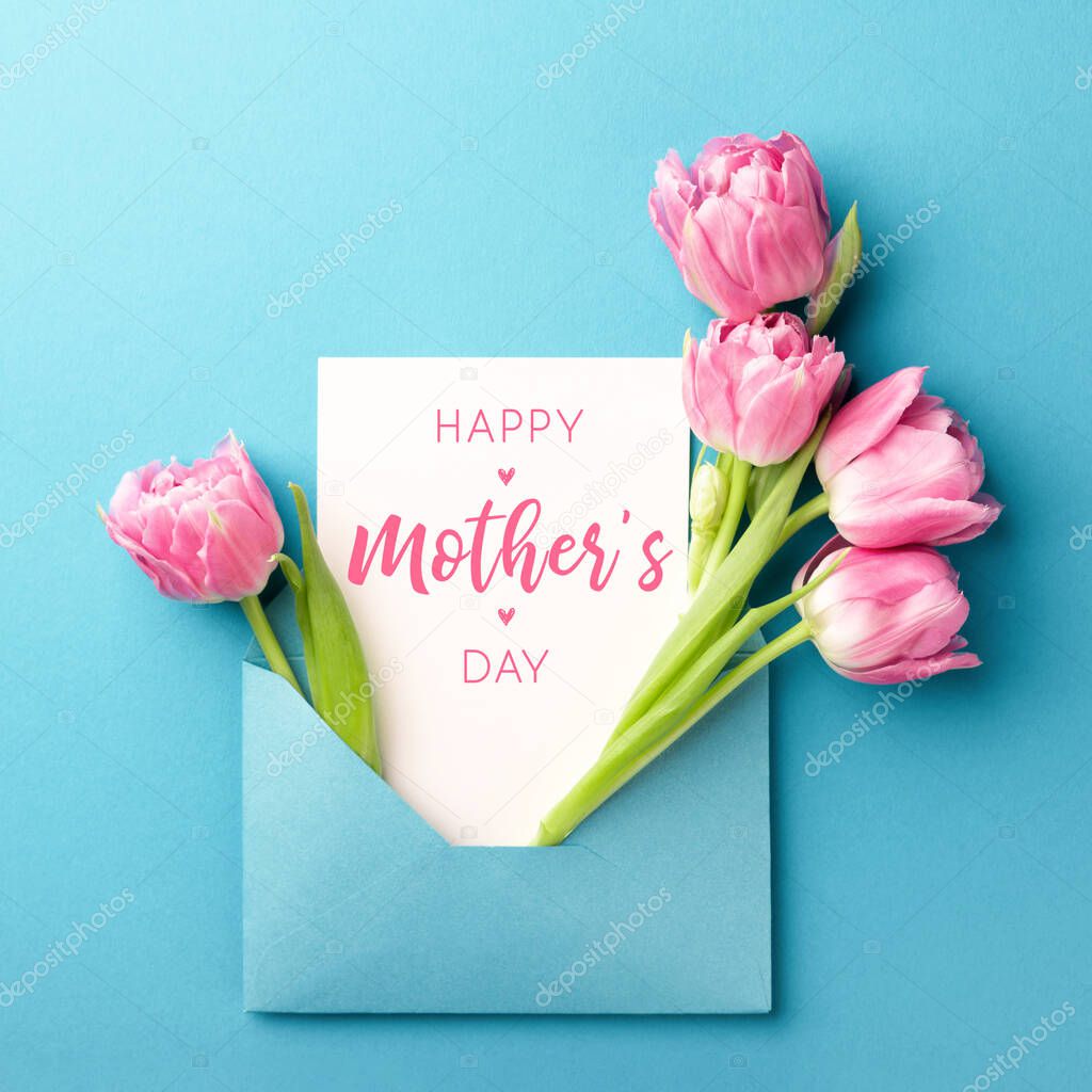 Pink tulips and white card in envelope.