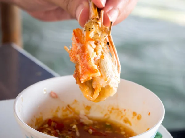 Dipping shrimp into spicy sauce. — Stock Photo, Image