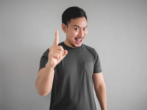 Knowing face of Asian man who got an idea and show one finger of solving.