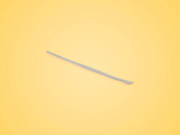 Stainless Steel Ear Pick Isolated Yellow Background — Stock Photo, Image