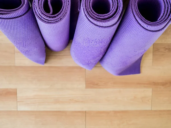 Rolls of yoga mats left in the room.