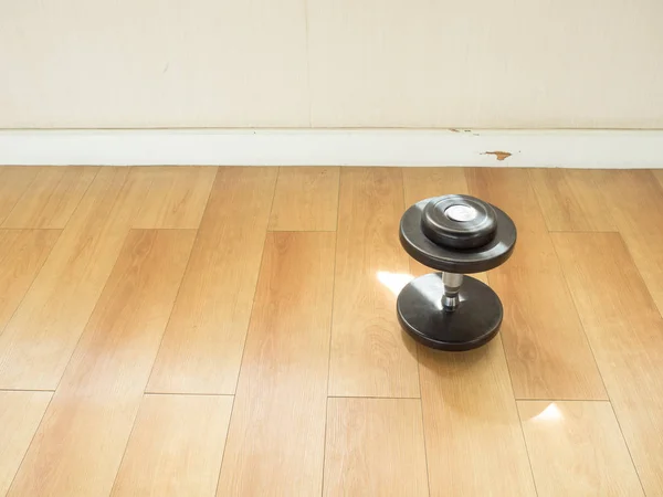 Dumbell left alone on the gym floor. — Stock Photo, Image
