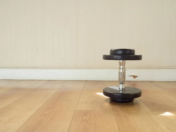 Dumbell left alone on the gym floor. — Stock Photo, Image