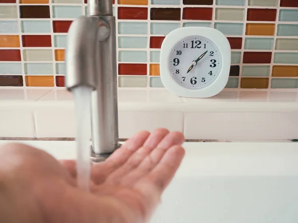 Concept of life routine with clock in the bathroom.