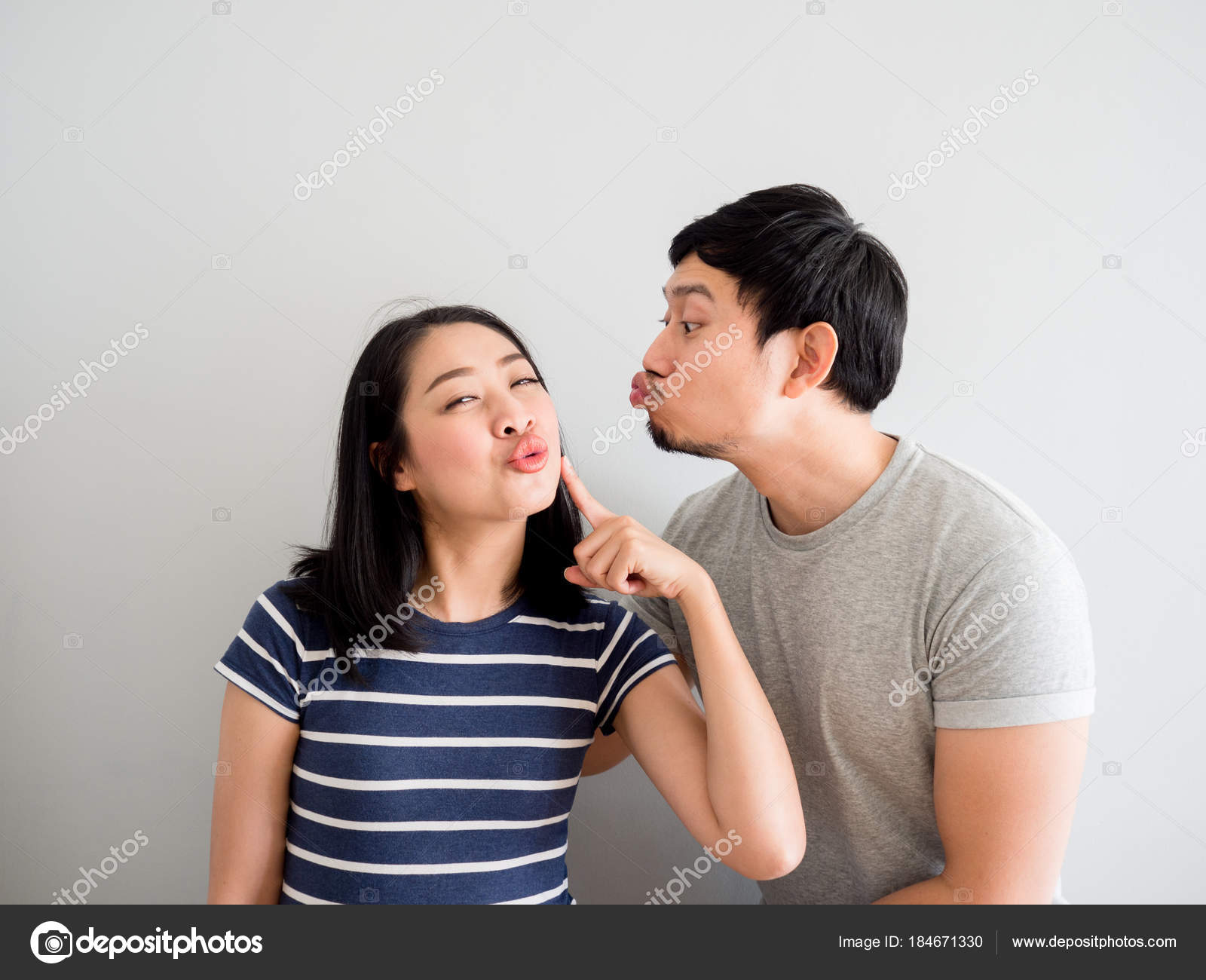 Funny lovely couple trying to kiss each other. Concept of comedy Stock  Photo by ©sevendeman 184671330