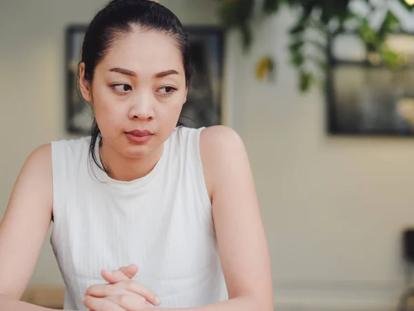 Lonely and sad woman is waitting for someone in the cafe.