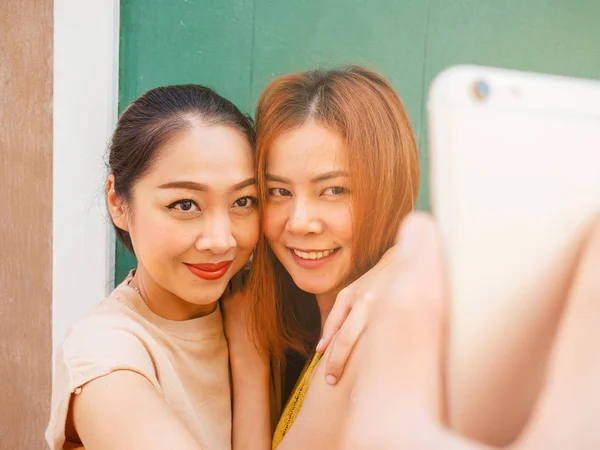 Two best friends women are taking selfie of thier trip.