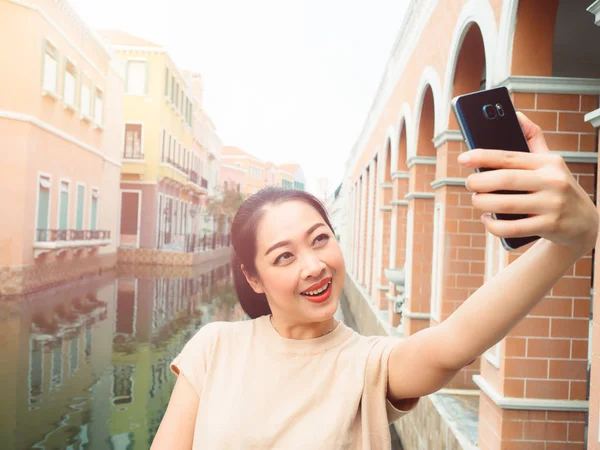 Turista mujer está tomando foto selfie desde el teléfono inteligente . —  Fotos de Stock