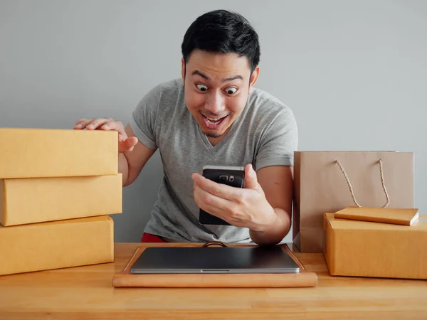 Asian man is feeling happyand  exciting with his online sales in the smartphone.