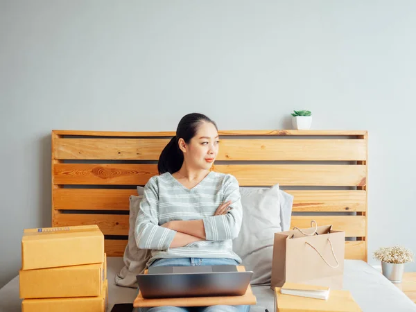 Asian woman ready to ship the products of her online store to the customer. Concept of work at home online business.