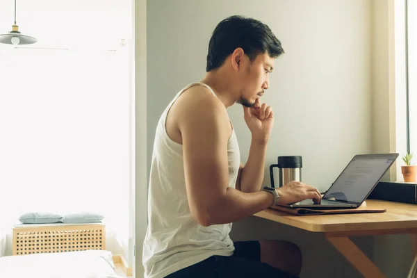 Man is working on his laptop in his house. — Stock Photo, Image