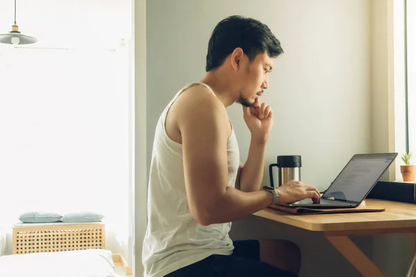 Man is working on his laptop in his house. — Stock Photo, Image