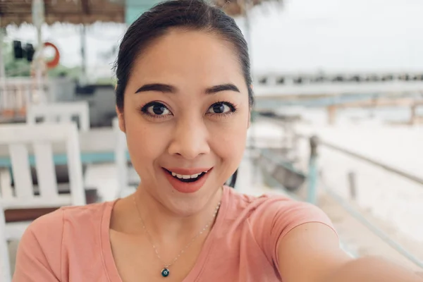 Mujer en camiseta rosa selfie ella misma con la cara feliz . — Foto de Stock