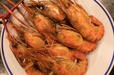 Steamed shrimps seafood served on dish.