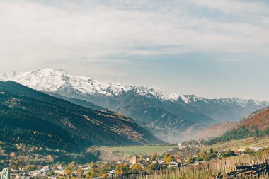 Landscape of small rural Mestia town in the valley with snow mountain of Georgia.