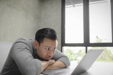 Odada tek başına çalışan bir adamın ciddi yüzü..