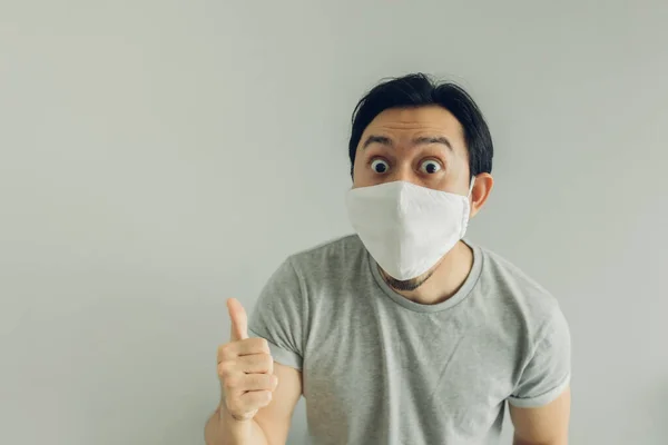 Wow face of man wearing hygienic mask and grey t-shirt.