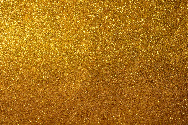 Gold blured sparkling background. Christmas lights.