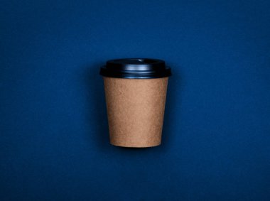 Tek kahverengi kağıt kahve fincanı mavi arkaplanda fotokopi alanı ile gidecek..