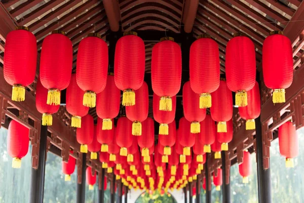 Red chinese lanterns hanging in a chinese bridge corridor