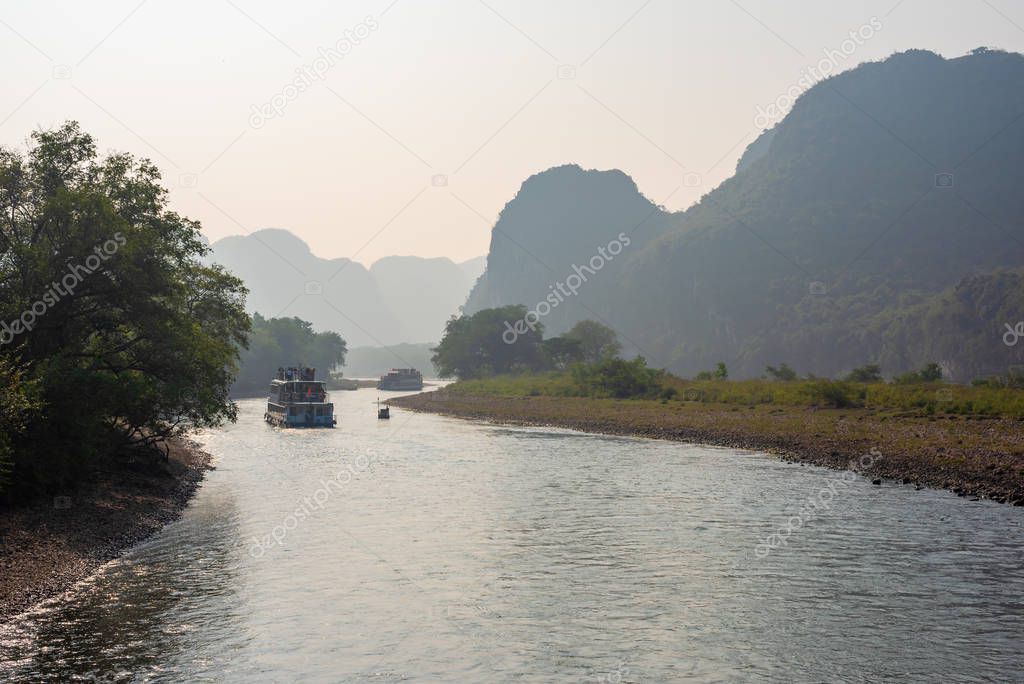 Boat on Li river cruise and karst formation mountain landscape in Guilin