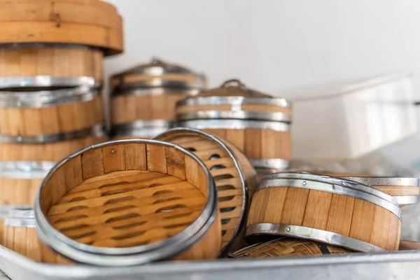 Stack of bamboo steamers in a kitchen