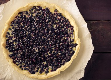Bilberry, lavanta beyaz tabakta, ahşap arka plan ile üzümlü tart