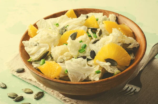 Chinakohl-Salat mit Orangen und Kürbiskernen auf Holzschüssel — Stockfoto