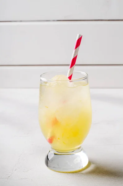 Ice lemonade with cocktail tube in glass, on white background. — Stock Photo, Image