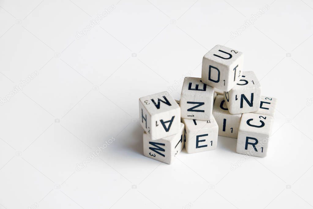 pile of cubes with letters and numbers on white 