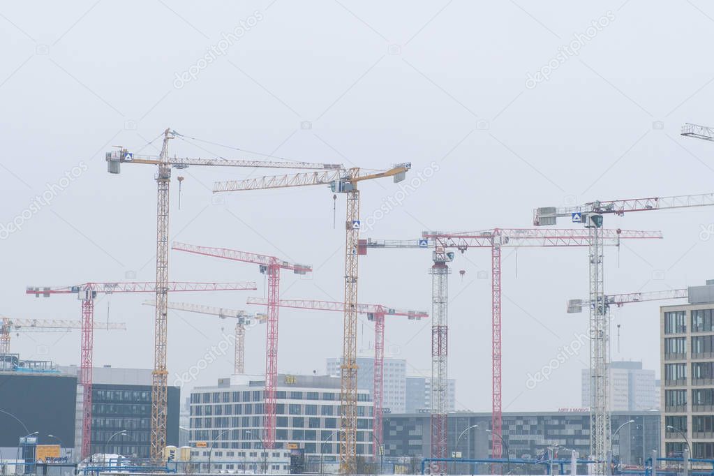 Berlin, Germany - January 8, 2017: Construction cranes  near the Mercedes Benz arena during winter in Berlin, Germany