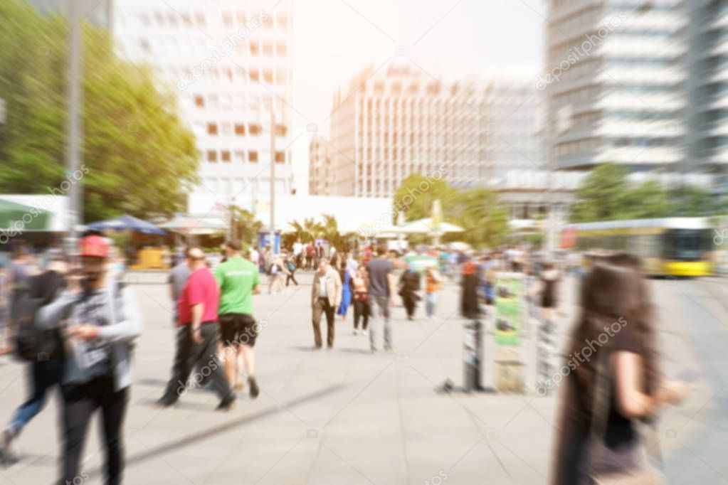  motion blur of a crowd of people crossing a city street at the 