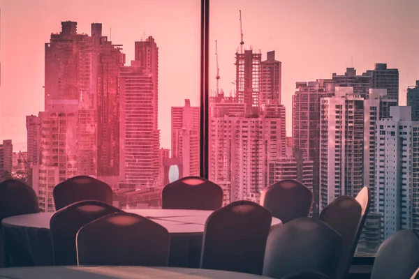empty conference room with view over modern skyline during sunse