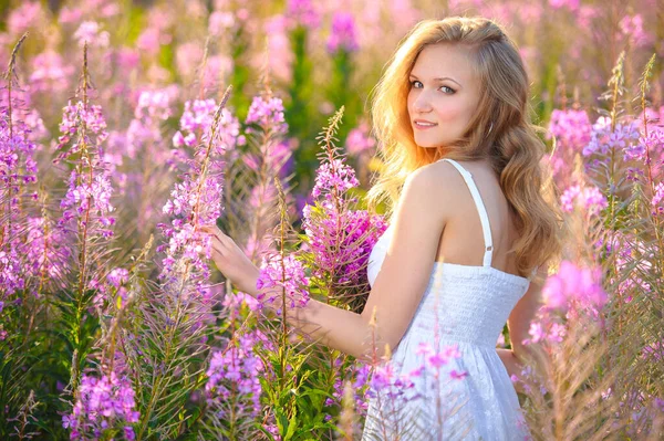 Νεαρή Όμορφη Ξανθιά Κοπέλα Συγκεντρώνει Ροζ Λουλούδια Στην Άνοιξη Ανθίζοντας — Φωτογραφία Αρχείου