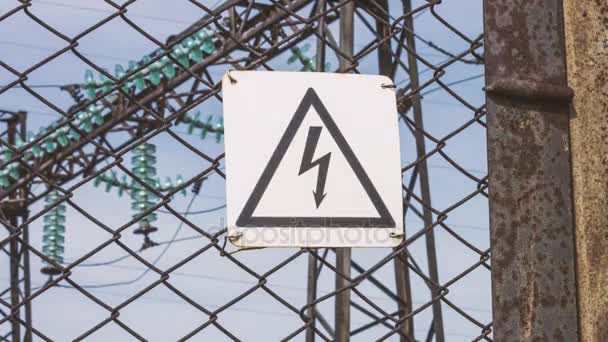 The danger sign of high voltage on the fence of the power plant. Risk of electric shock. Power generators, electricity generation and transportation to cities. Power engineering. Stand - high voltage — Stock Footage The danger sign of high voltage on the fence of the power plant. Risk of electric shock. Power generators, electricity generation and transportation to cities. Power engineering. Stand - high voltage Stock Video