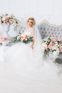 Çiçeklerle çevrili bir gelinlik güzel bir kız portresi
