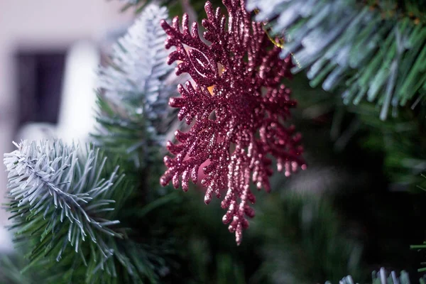 Noel oyuncak parlak kar taneleri bir Noel ağacı dalları üzerinde asılı şeklinde — Stok fotoğraf