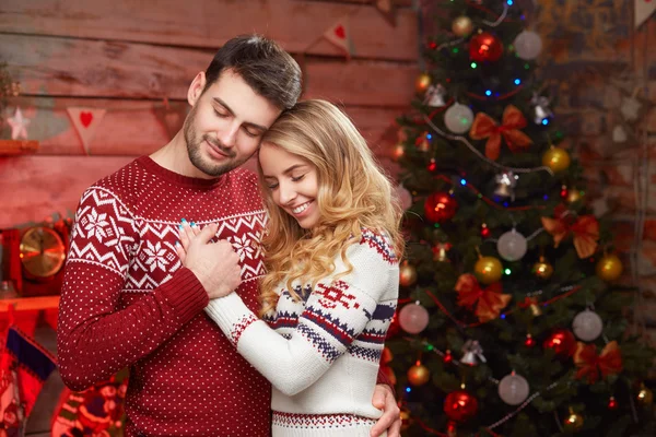 Happy couple in love over christmas tree — Stock Photo, Image